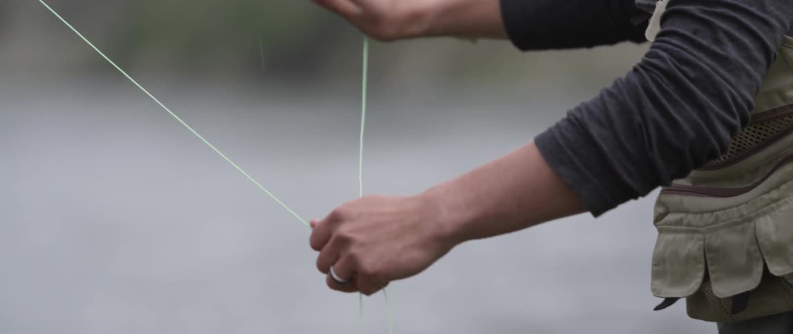 A man is fly fishing in a river