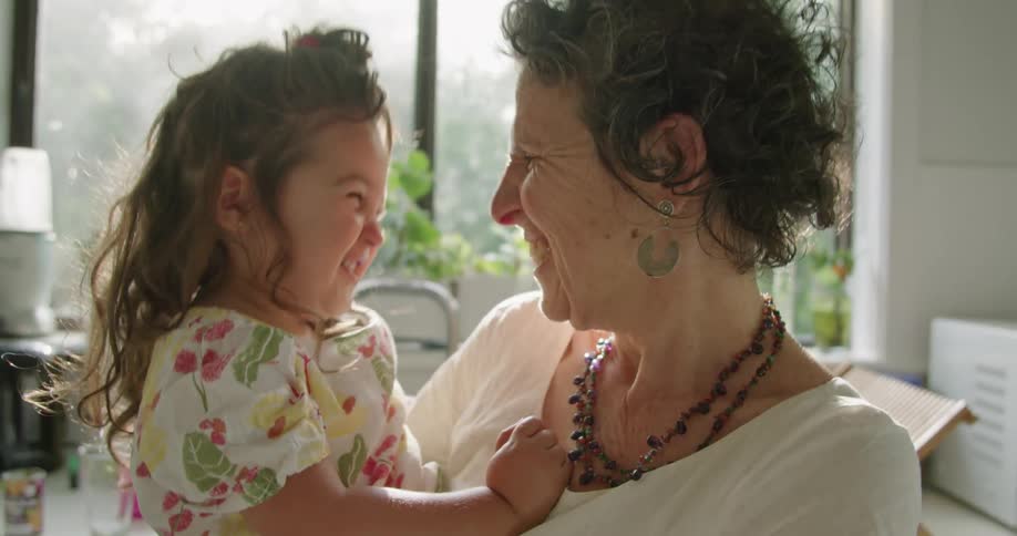 A granddaughter and granddaughter rub noses together