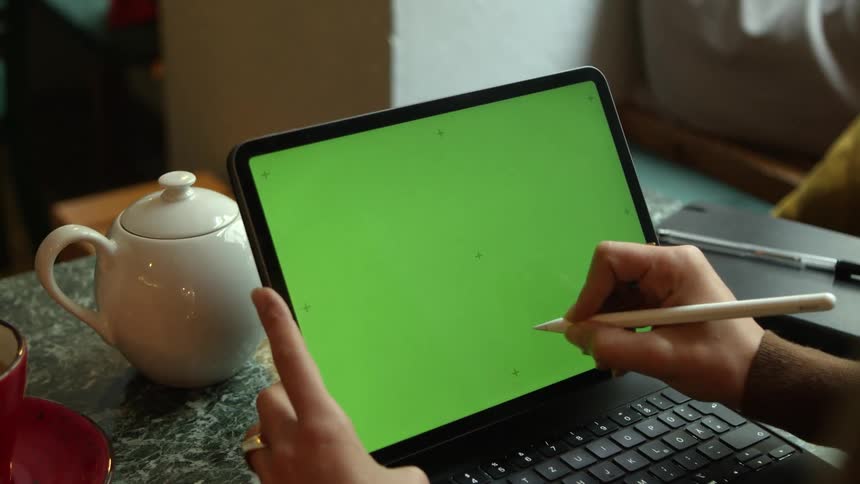 Someone is touching a laptop computer screen with a stylus