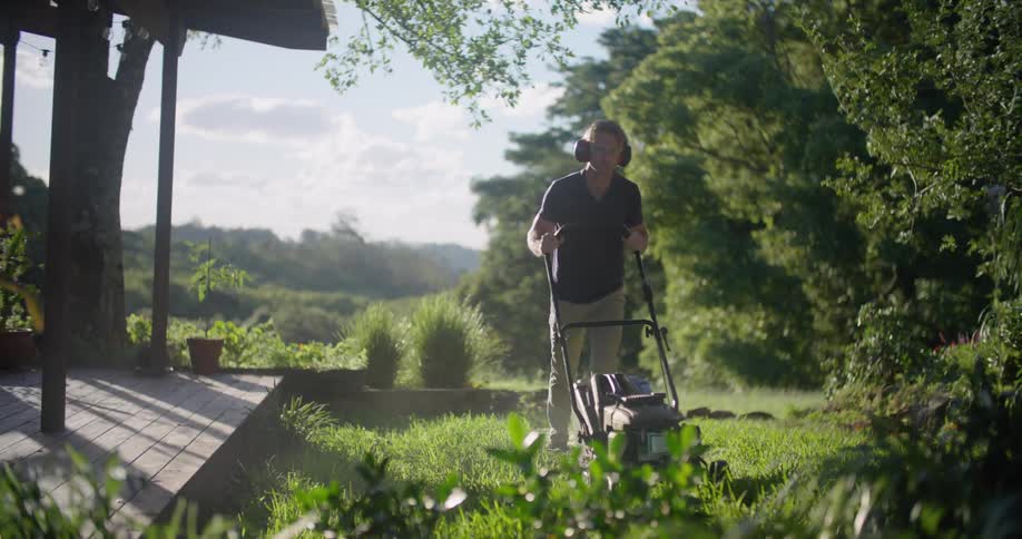 A man is mowing his lawn
