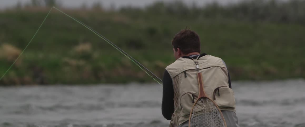 A man fishes in a river