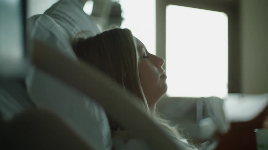 A pregnant woman laying back in a hospital bed