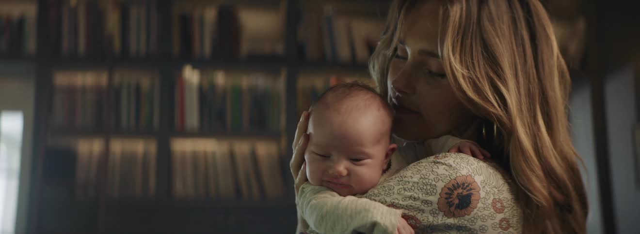 A woman is cradling her son
