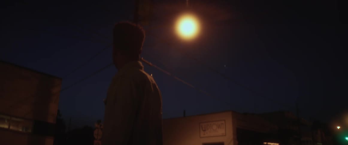 A man is turning around in a circle in the middle of the street