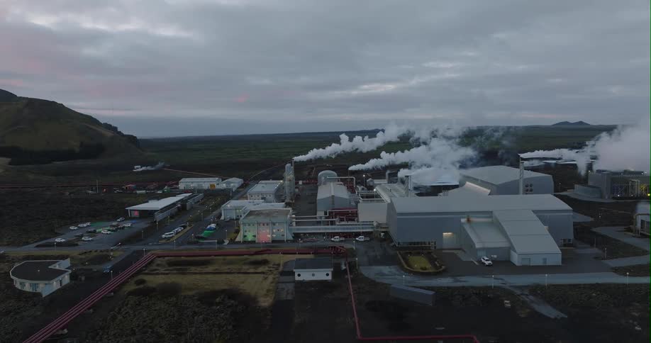 Aerial view of white smoke over a factory
