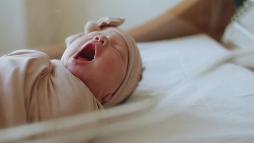 Baby yawning while sleeping