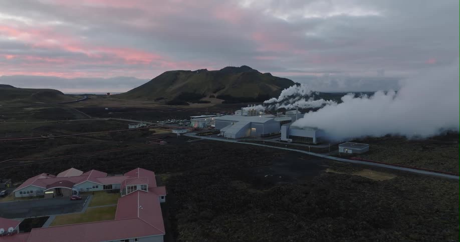 An aerial view of smoke billowing from a factory