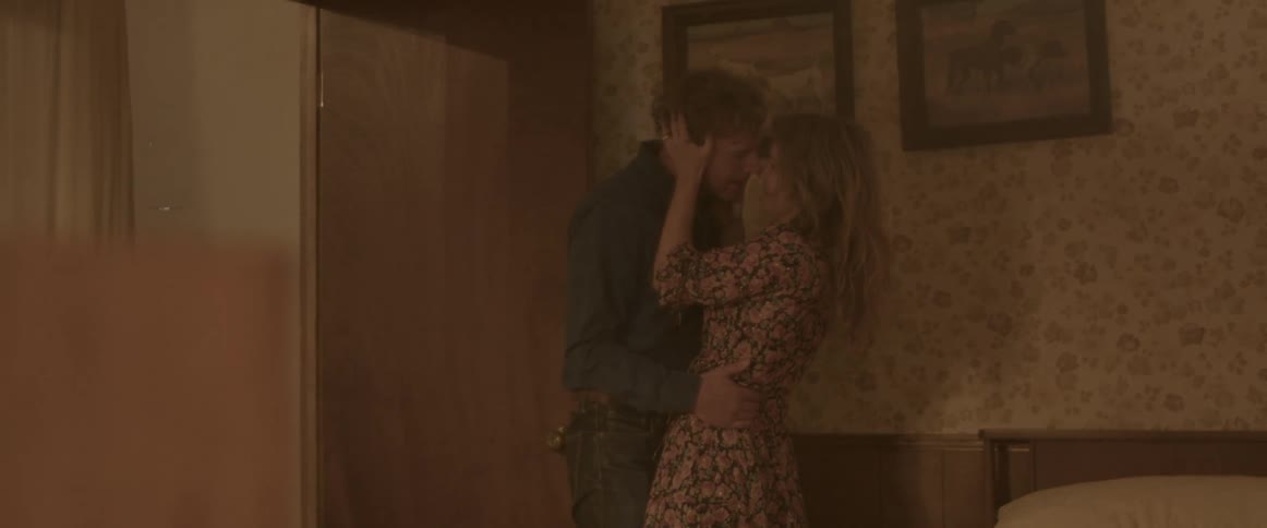 A couple kiss in the bedroom