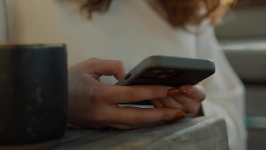 A woman is flipping through information on her smart phone