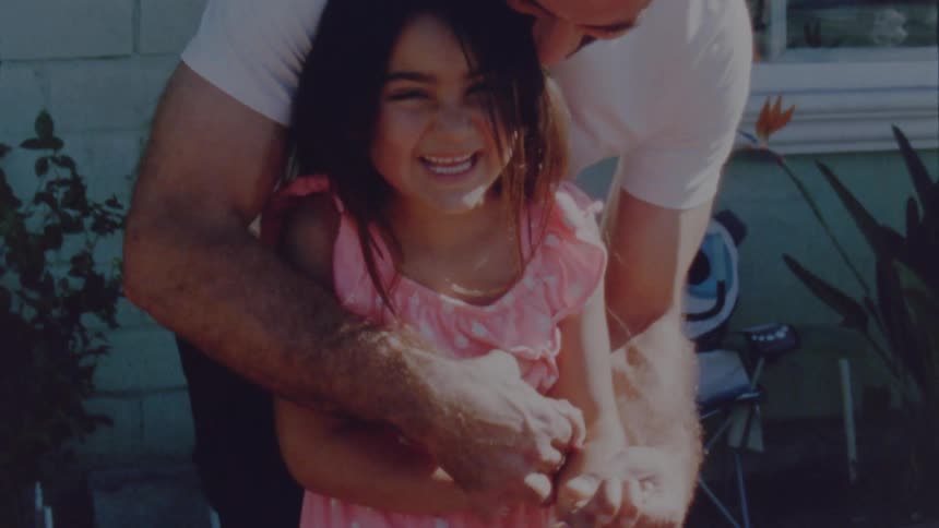 A father tickles his daughter