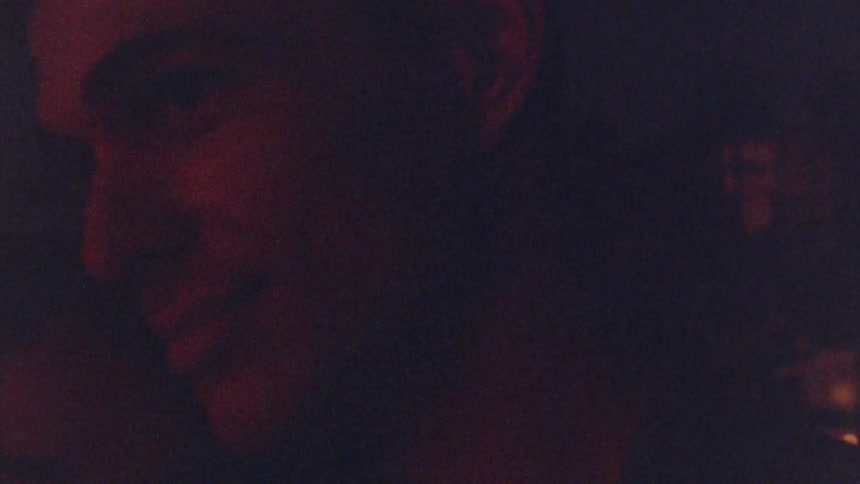 A couple kiss in the dark