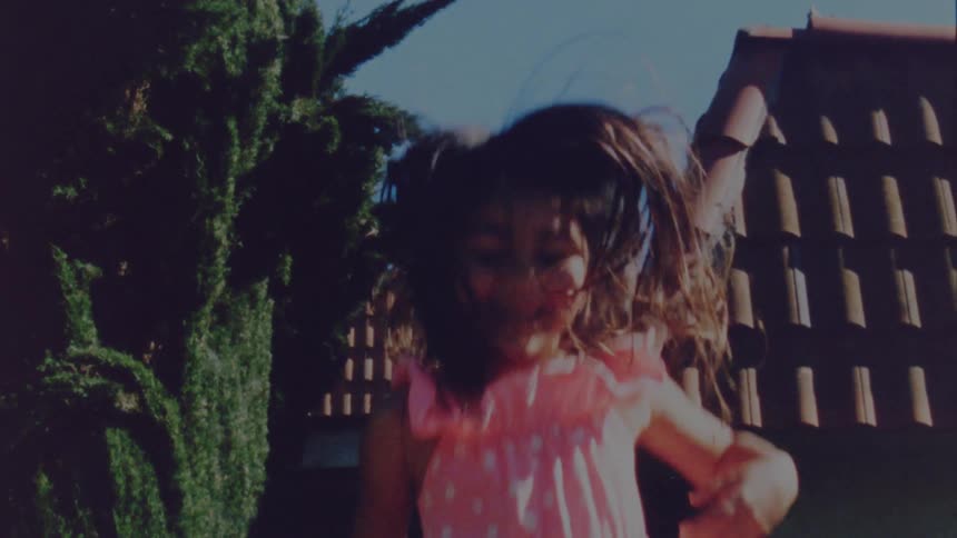 A child is jumping outdoors in spring