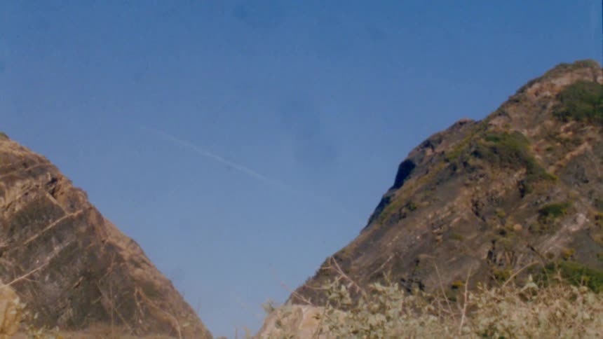 View of two mountain slope and valley with blue sky