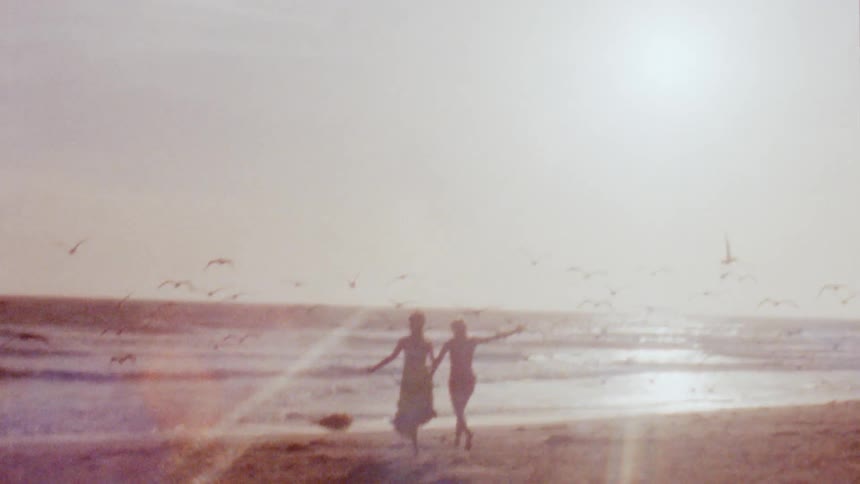 Two women running and having fun on the beach