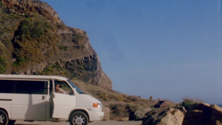 Women arrive at beach in van and get out of vehicle
