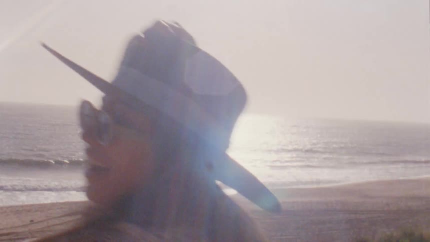 Woman jumps out of van and runs out toward ocean celebrating