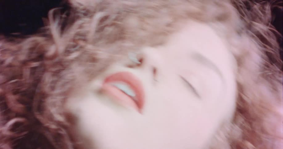 Closeup view of a woman dancing outdoors at night