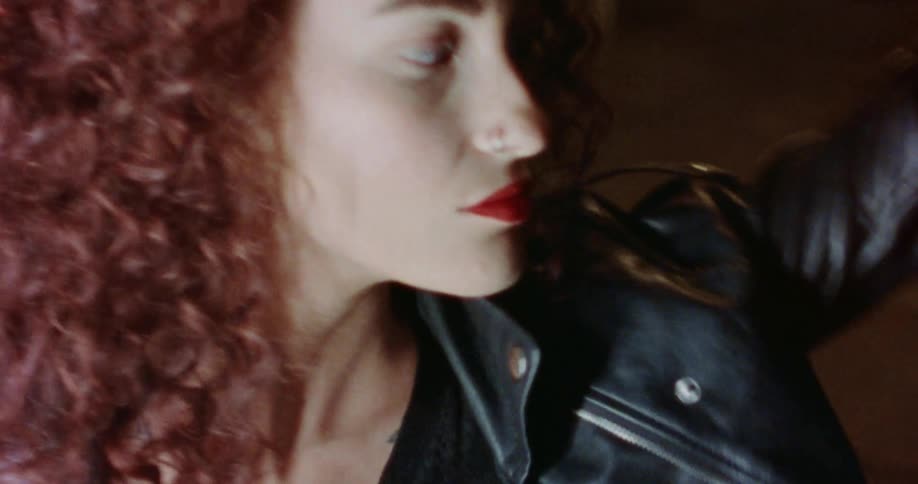 A woman is having fun and wearing a leather jacket