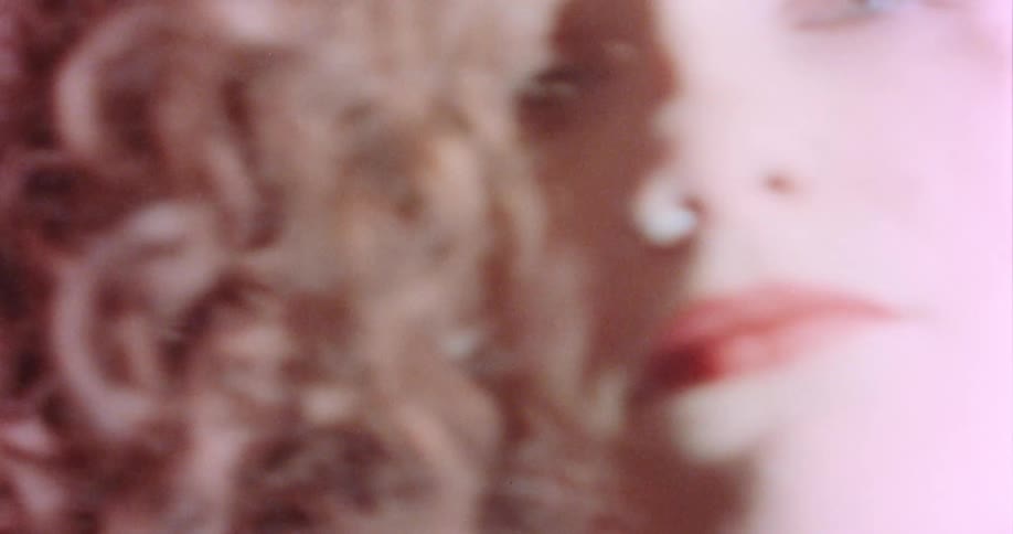 Female ginger haired woman looking at camera