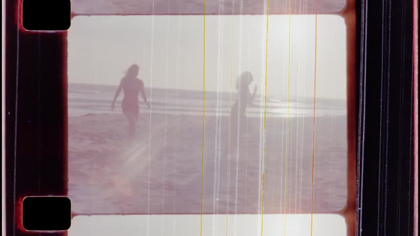 Two women running around on the beach