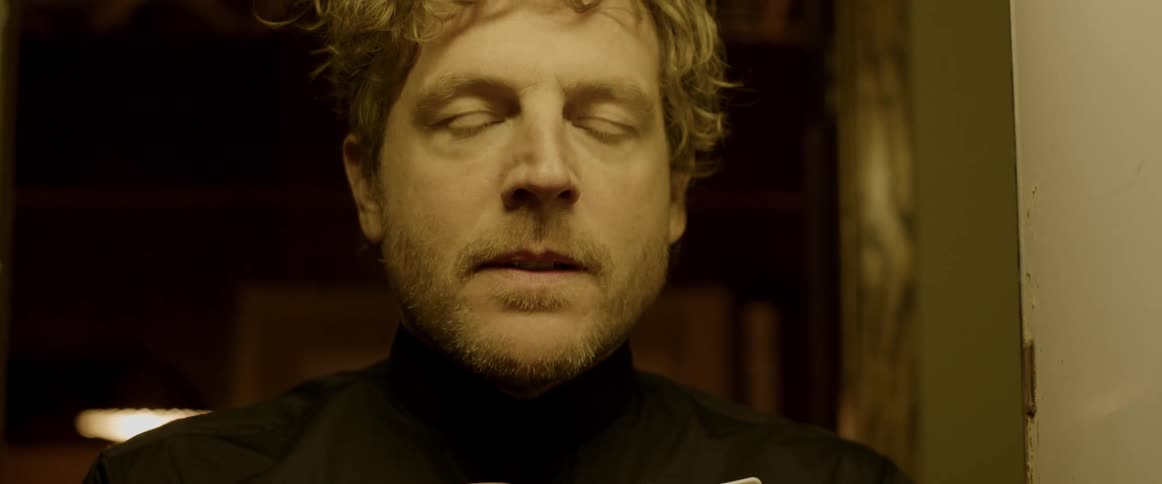 A priest removes his clerical collar