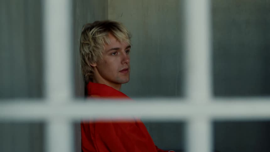 Male sitting in jail cell