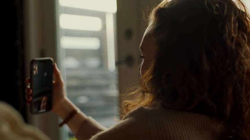 A woman is talking on video phone