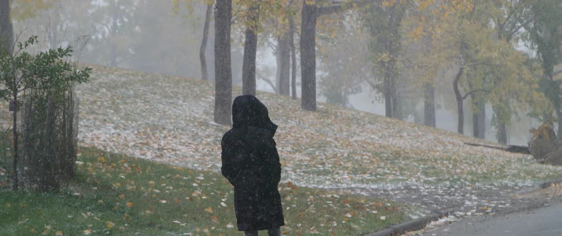 A woman walking outdoors in a snowy day