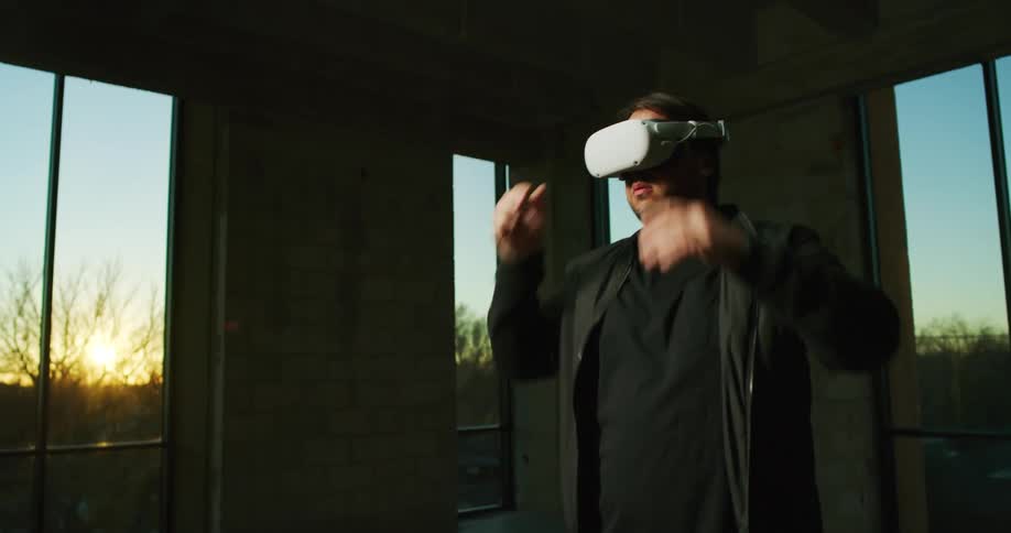 A man in a house puts on virtual reality goggles