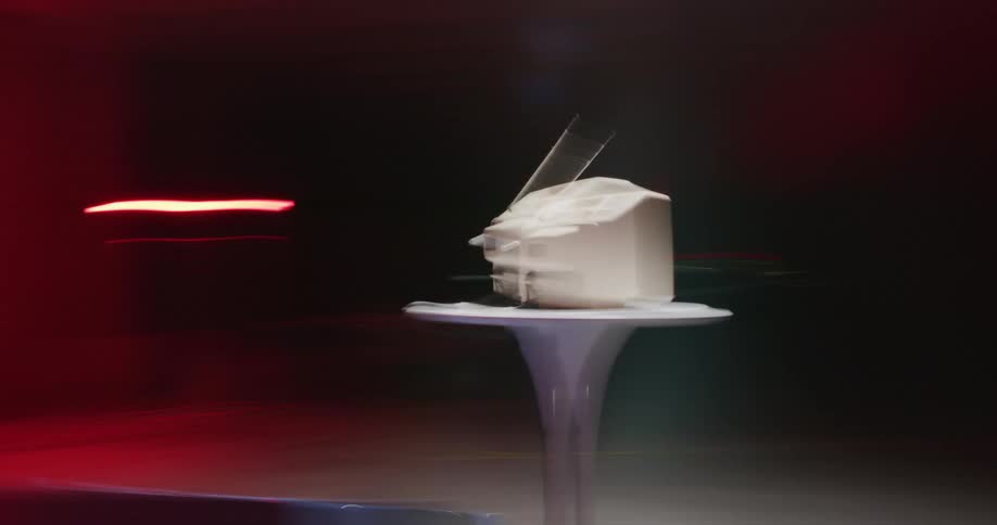 A timelapse of a small television spinning in a room with bright lights