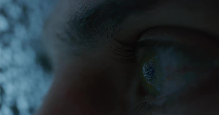 A person leans in close to the television