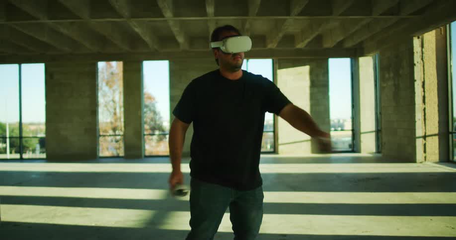 A man plays a vr headset inside a building under construction