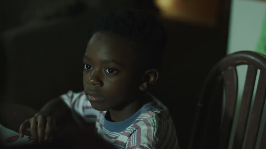 A child sitting at a table yelling