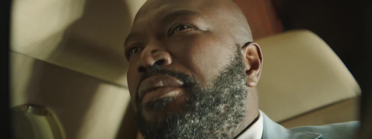 Bald bearded man sitting on a dark plane with strobe white lights