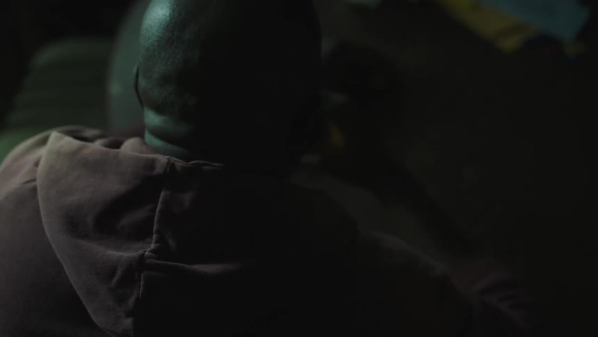A man sits down and drinks a beer