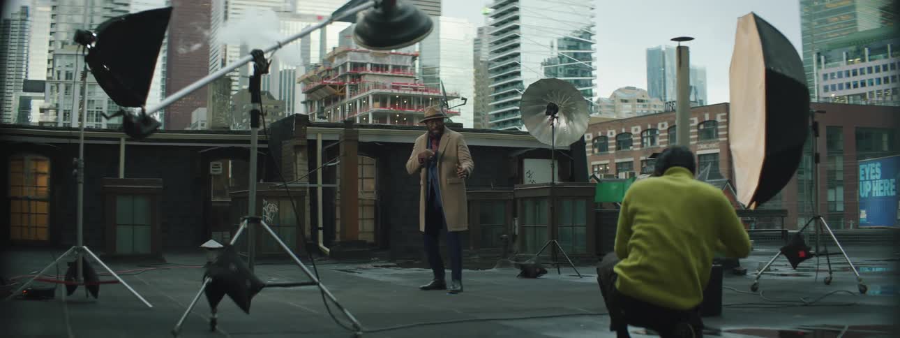A photographer taking pictures of a model outdoors
