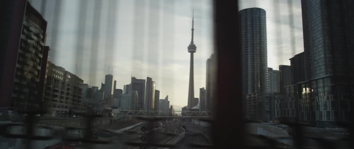 Moving fast past a railing facing a large city