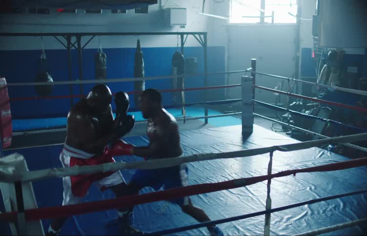 Two men are boxing in the ring