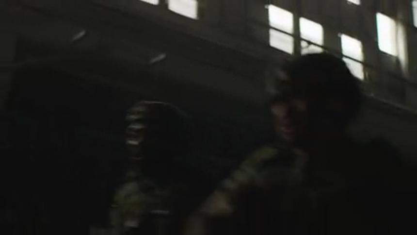 Soldiers run through the building together