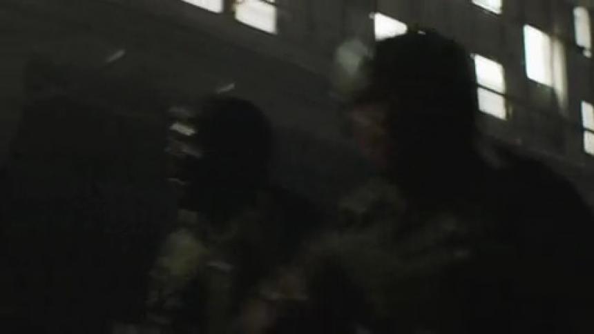A group of military soldiers are running through a building