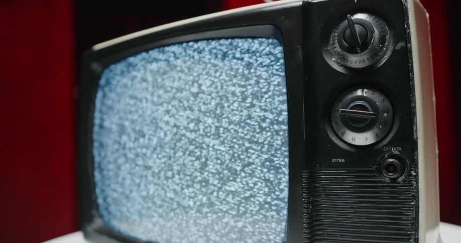 A view of a vintage tv with static on the screen