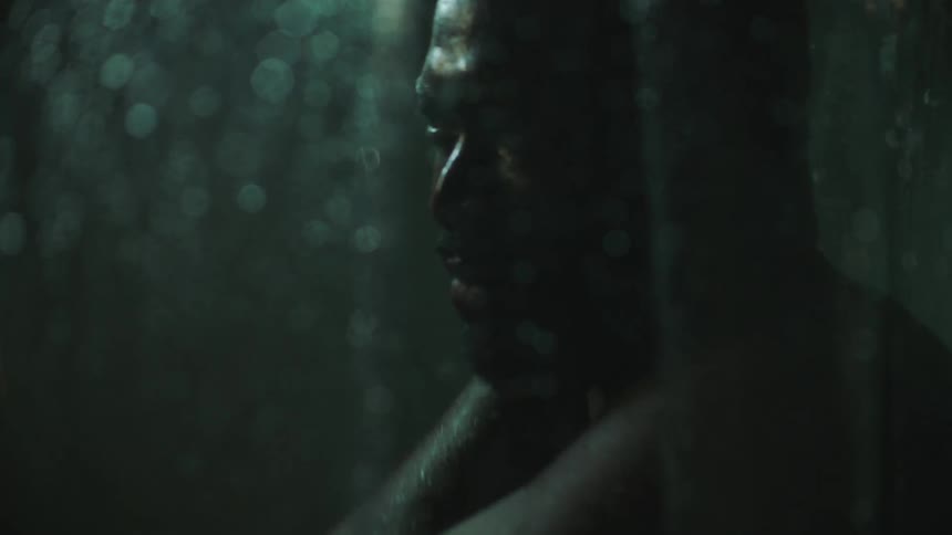 A man is washing in the shower