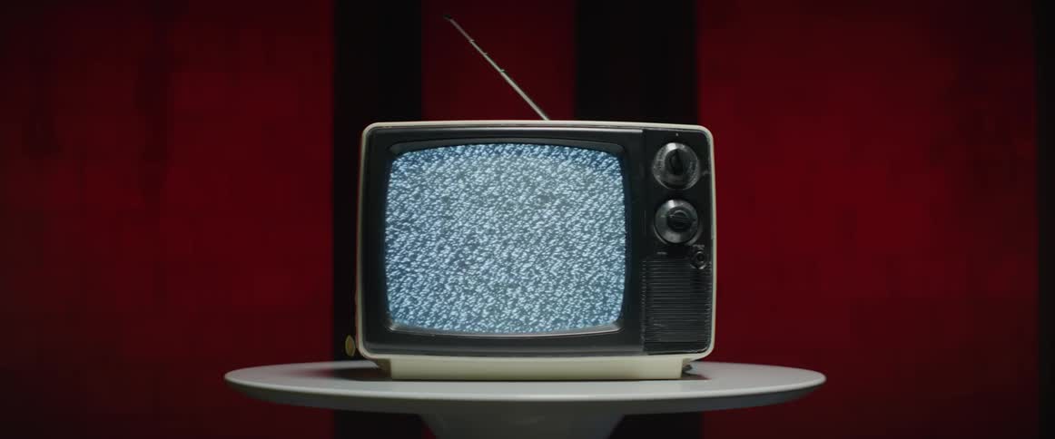 A view of a vintage tv with static on the screen