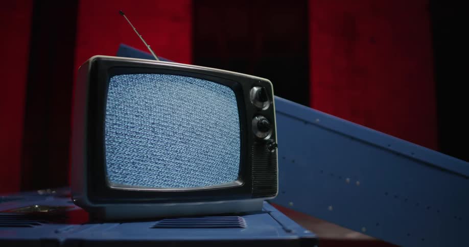 An old television is sitting on a table indoors