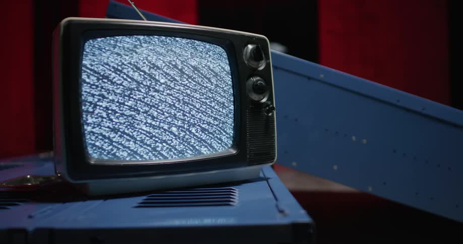 An older television set is turned on and only showing static