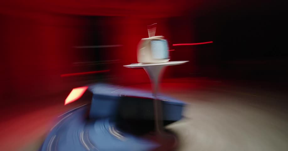 Blue lockers on the ground under a table with a small television on it playing static