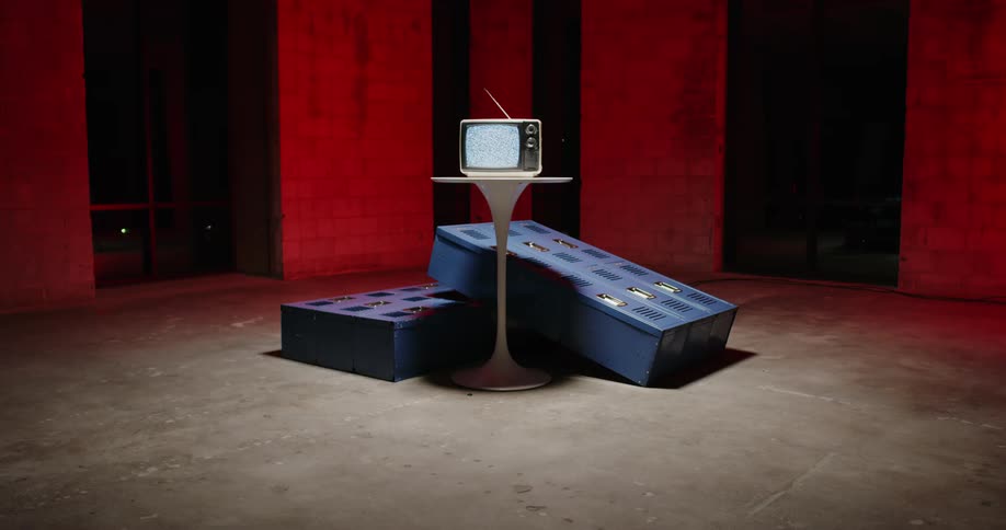 A television is displaying static in the red room