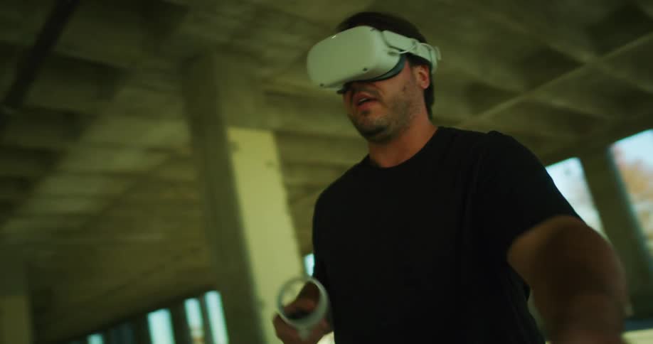 A man swinging his arms while playing a virtual reality game