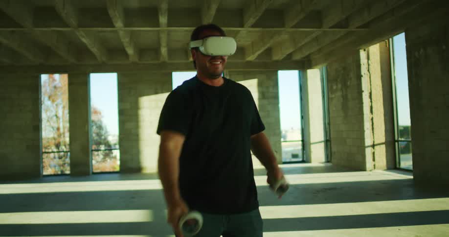 A man is swinging his arms while playing a game on virtual reality