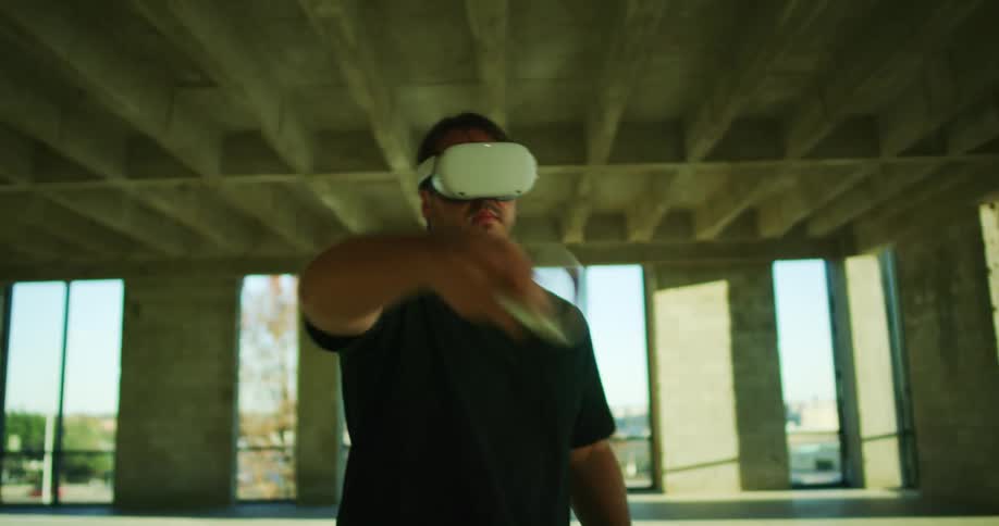 A man is playing virtual reality outdoors in spring